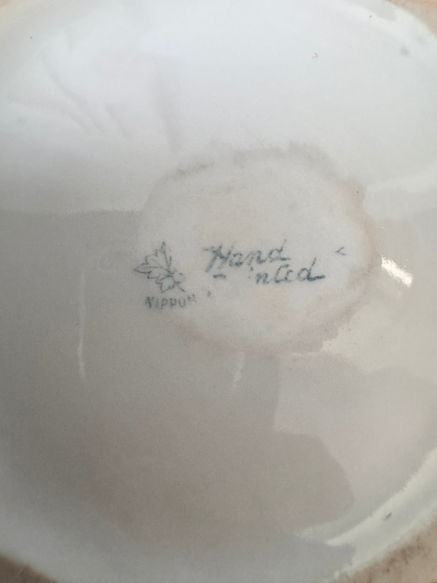 Hand-painted Nippon porcelain chocolate pot and saucer with raised gold detailing.