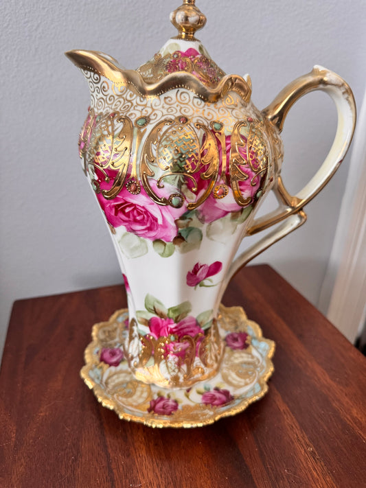 Hand-painted Nippon porcelain chocolate pot and saucer with raised gold detailing.
