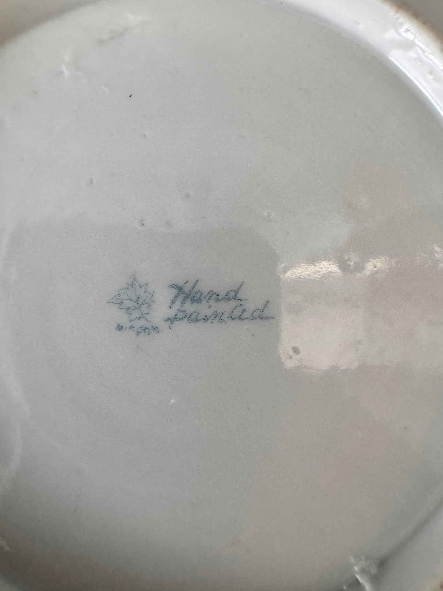 Hand-painted Nippon porcelain chocolate pot and saucer with raised gold detailing.