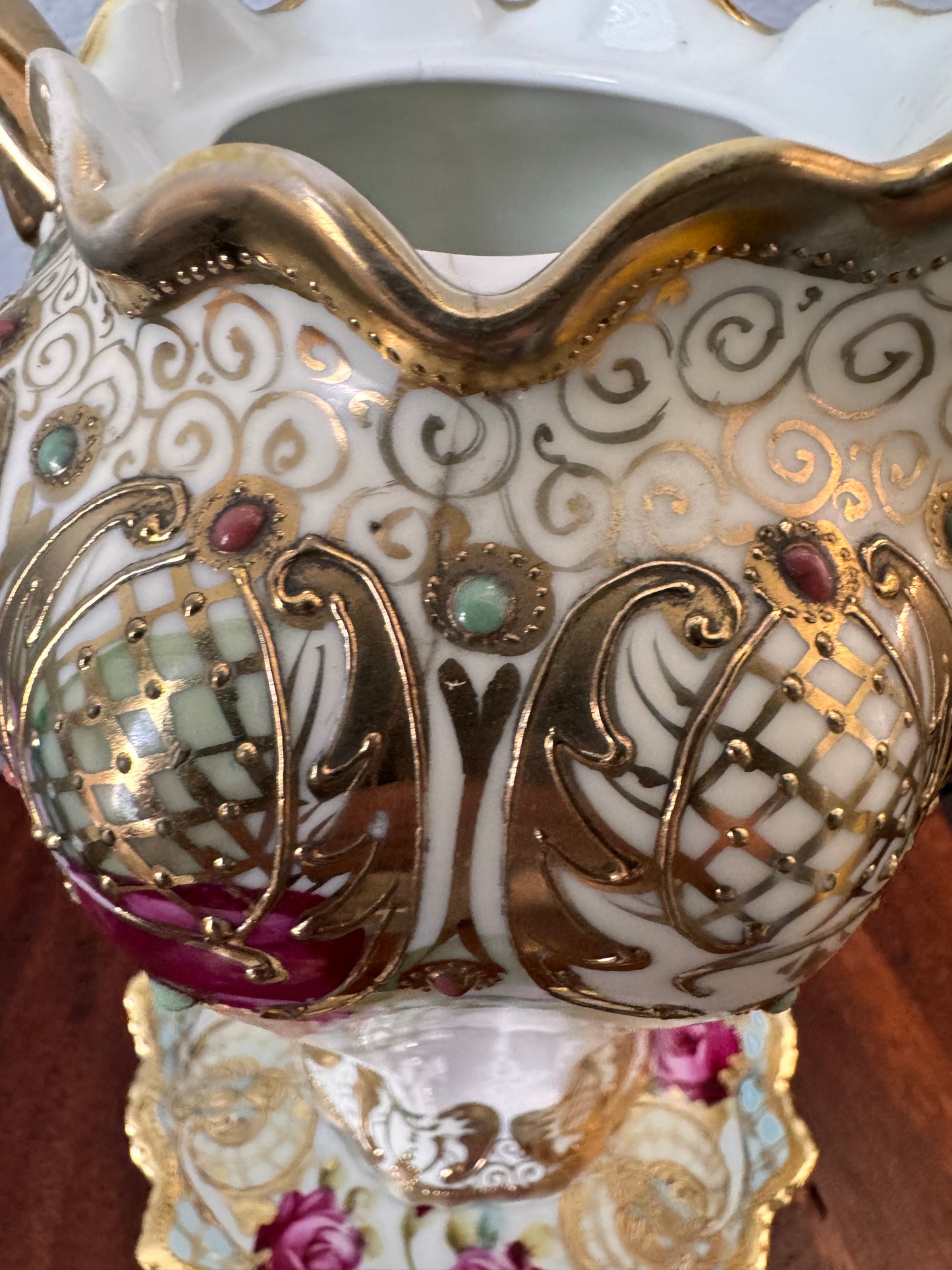 Hand-painted Nippon porcelain chocolate pot and saucer with raised gold detailing.