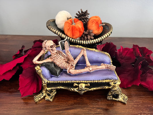 Skeleton on Sofa Reading